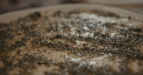 Close up slider shot of fresh basil on pizza dough Stock Footage 105299127