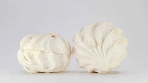 A Close-Up Slider Shot From Left To Right Showing Two White Marshmallow Desserts Video stock 320889242