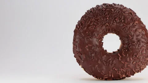 A Close-Up Slider Shot Pans Across A Chocolate Frosted Donut With Sprinkles, Iso Stock Footage 320890210