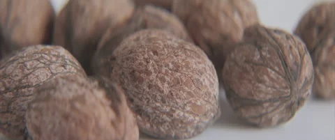 Close-up sliding on common walnuts on table 4K scope footage Stock Footage 319954823
