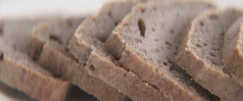 Close-up sliding on gluten-free bread slices 4K anamorphic video Stock Footage 321857210