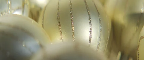 Close-up sliding on golden bauble with sequins 4K scope video Stock Footage 317367184
