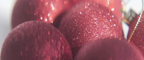 Close-up sliding on red baubles with sequins anamorphic 4K sliding video Stock Footage 317075501