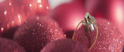 Close-up sliding by sequined red baubles 4K scope video Stock Footage 317802224