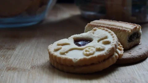 Close sliding shot left of stack pile of 3 biscuits on wooden kitchen Stock Footage 98972141