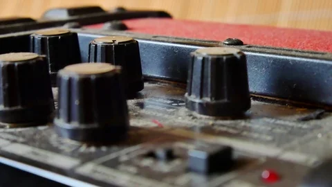 Close up sliding view across tuning knobs &amp; controls on guitar amp. 動画素材 100225721