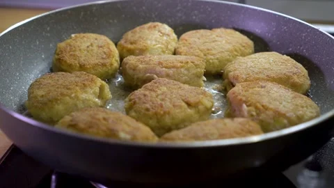 Close-up sliding view of frying fresh delicious meatballs on a hot pan 스톡 동영상 245443902