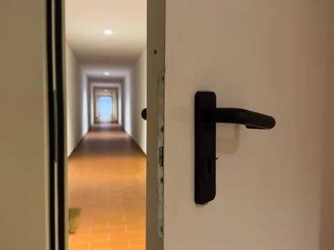 Close-up of a slightly opened hotel suite door with a modern keycard lock a.. Stock Photos