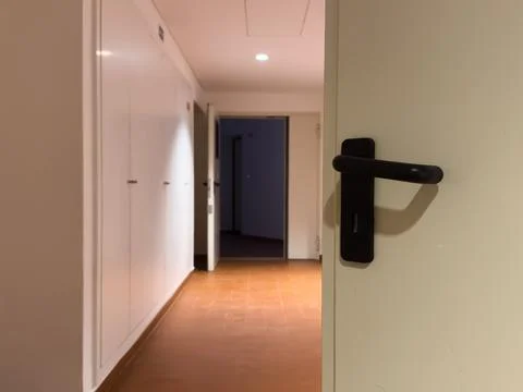 Close-up of a slightly opened hotel suite door with a modern keycard lock a.. Stock Photos