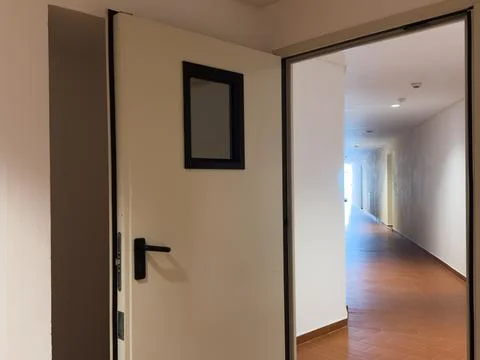 Close-up of a slightly opened hotel suite door with a modern keycard lock a.. Stock Photos