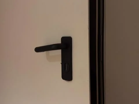 Close-up of a slightly opened hotel suite door with a modern keycard lock a.. Stock Photos