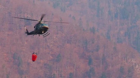 Close up Slovenian Armed Forces helicopter with a specialized bucket Stock Footage 182396690