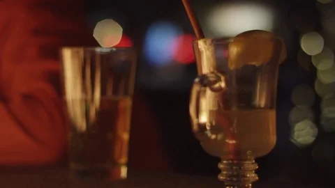 Close Up Slow Mo of Drinks in front of Fire With Bokeh Background 動画素材 83360618