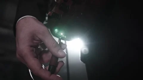 A close-up of a slow-mo musician plugging his guitar into an amplifier before Stock Footage 169587895