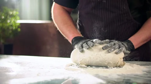Close-up slow mo shot of chef's hands kneading dough Stock Footage 137318526