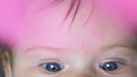 Close-up in slow motion of baby's beautiful blue eyes Stock Footage 114104897