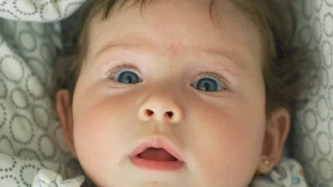 Close-up in slow motion of beautiful baby looking at camera Stock-Footage 114644635