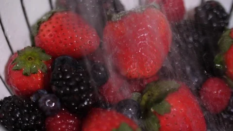 Close up slow motion of berries being washed with a fine spray of water. Stock Footage 86536192