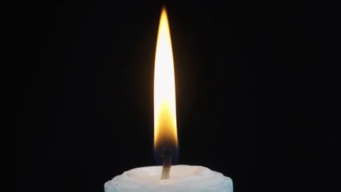 Close up slow motion blowing out a spinning candle isolated black background Stock Footage 279039845