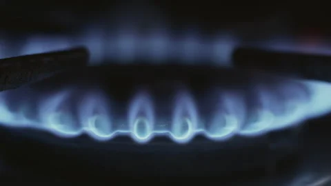 Close-up, slow motion, burning gas burner of a kitchen stove on a black 库存影片 337118504