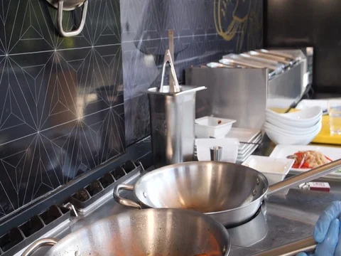 Close up slow motion of a chef cooking duck breast by gas in a frying pan Stock Footage 79975768