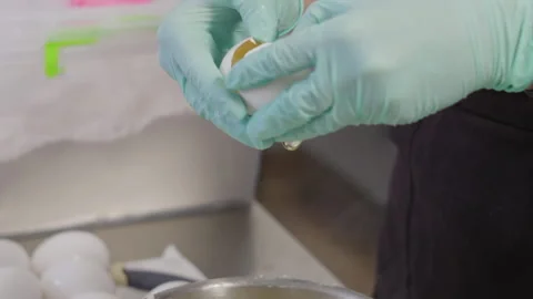 Close-up, Slow Motion, Chef's Hands in Gloves Break Egg into Cream Mass Welded Stock Footage 136779464