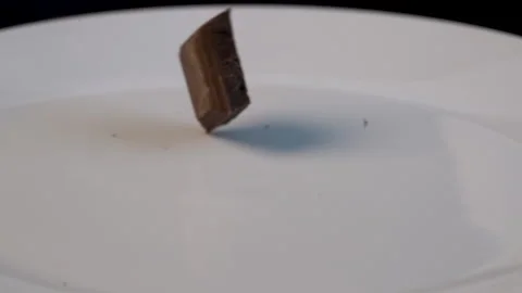 Close up slow - motion chocolate falling down on the plate Видео 136210140