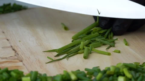 Close up Slow-motion, chopping Spring onions on the chopping block by chef. Stock-Footage 137074547