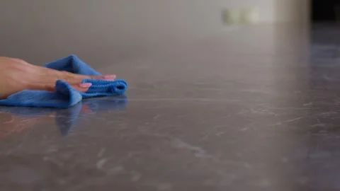Close-up slow-motion cleaning product is sprinkled on the table and wiped with a Vidéo 267535867