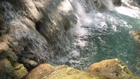 Close up slow motion of a clear waterfall flowing in the mountains Stock Footage 321860476