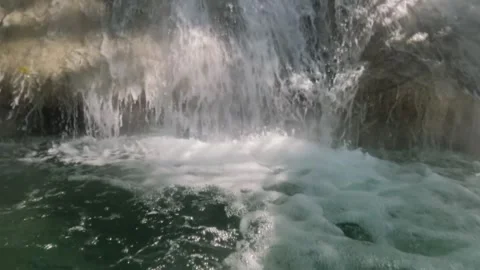 Close up slow motion of a clear waterfall flowing in the mountains Stock Footage 321860539
