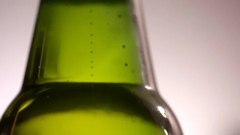 Close up slow motion clip of beer bubbles in a bottle Stock Footage 87857409