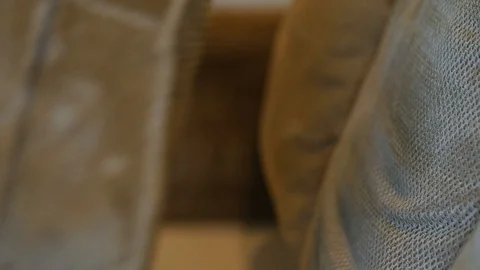 Close up slow motion clip of couch cushion being cleaned by a wet vacuum Stock Footage 85868481