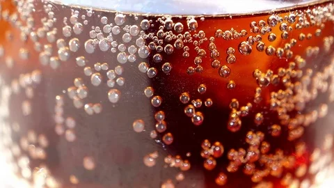 Close up of slow motion cola with ice and bubbles Video stock 76442134