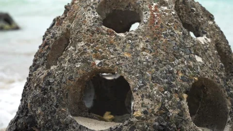 Close up slow motion of concrete reef ball burials with holes for fish on the Stock Footage 270164063