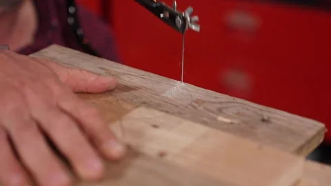 Close Up Slow Motion of Craftsman Cutting Wood With Scroll Saw in Workshop Stock Footage 334700847