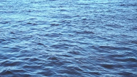 Close-up slow motion of the disturbed blue water surface of a deep river, soft Video stock 189893114