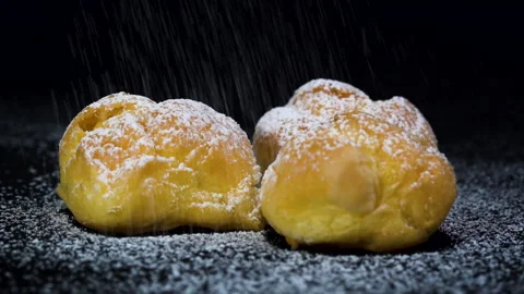 Close up slow-motion Eclairs with more icing on top black background Видео 135852457