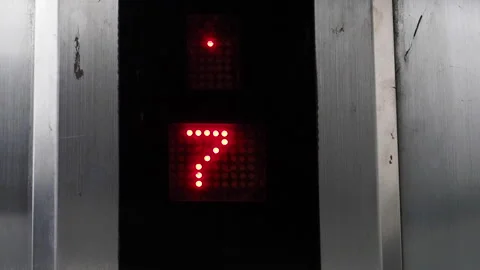 Close-up slow-motion of an elevator screen, changing floor numbers Video stock 295984710