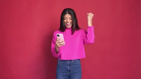 Close up slow motion face of young woman, isolated on red background Stock Footage 233461757
