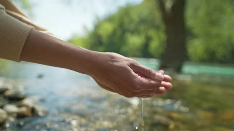 Close up slow motion female hands taking fresh cold clean water in palms from Stock Footage 224486464