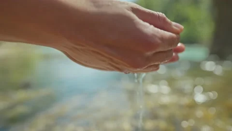 Close up slow motion female hands taking fresh cold clean water in palms from Stock Footage 224486855