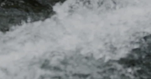 Close Up Slow Motion Flowing River Water with Rocky Shore Stock-Footage 336806174