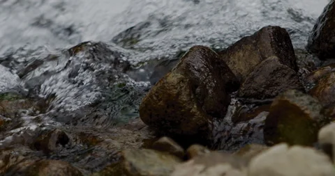 Close Up Slow Motion Flowing River Water with Rocky Shore 動画素材 336806348