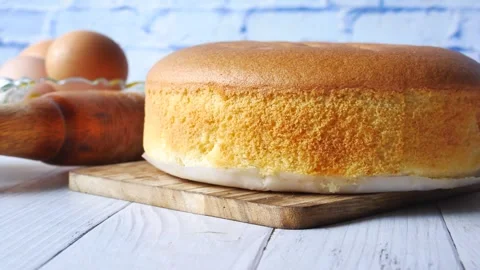 Close up slow motion footage of fluffy sponge cake with eggs and rolling pi.. Stock Footage 333154417