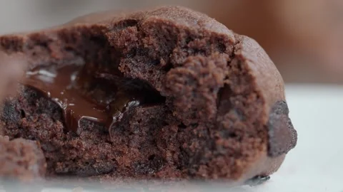 Close up slow motion footage of melting chocolate oozing from a decadent br.. Stock Footage 332117645