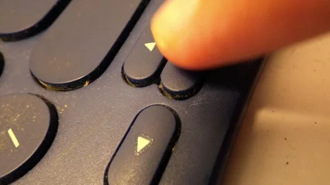 Close-Up Slow Motion Footage of Pressing Arrow Keys on a Bluetooth Keyboard Stock Footage 319513031