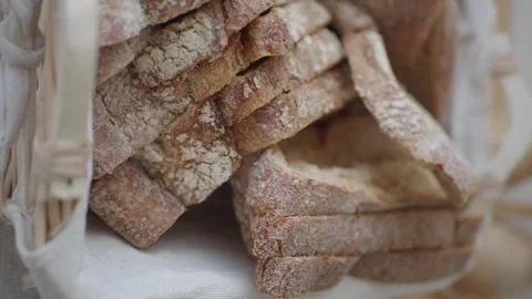 Close up slow motion footage of sliced bread in rustic basket for dining. Stock Footage 332034749
