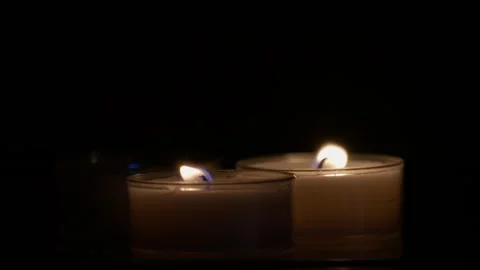 Close-up slow-motion footage of a tea light candles burning in the dark Stock-Footage 250028114