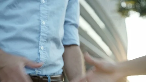 Close up slow motion footage of two people shaking hands. Stock Footage 99847743